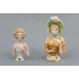 A porcelain "pin lady" together with a similar earthenware example, circa 1920s - 1930s, 7 cm and