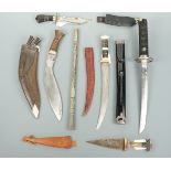 A reproduction Japanese wakizashi, a kukri, baton and ethnic knives and daggers