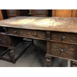 A late 19th / early 20th Century carved oak knee hole desk, 147 cm x 91 x cm x 76 cm high