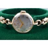 A 1950s lady's Rolex 9 ct gold wristlet watch, having a Precision movement and frosted silver face