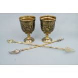 A pair of large Indian bidri ware goblets together with two brass toasting forks