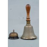 A hand bell, 26 cm high, together with a desk bell