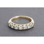 A diamond and high-carat yellow metal half hoop eternity ring, the face divided into seven cells,