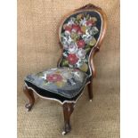 A Victorian carved and beadwork upholstered walnut spoon-back nursing chair