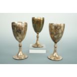 A set of three Elizabeth II silver goblets / chalices, each with ovoid bowl, an acanthus knopped