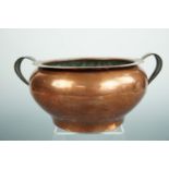 A Keswick School of Industrial Art copper cachepot of shouldered form with strip handles, 22 cm x 10