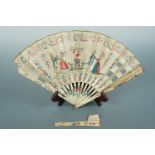 A mid 18th Century French folding fan, the paper leaf printed and punched with a fete galant, hand-