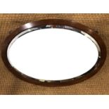 An early 20th Century mahogany oval wall mirror, 83 x 57 cm