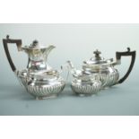 A Victorian silver bachelor's tea service, of Georgian influence, gadrooned, comprising tea pot, hot
