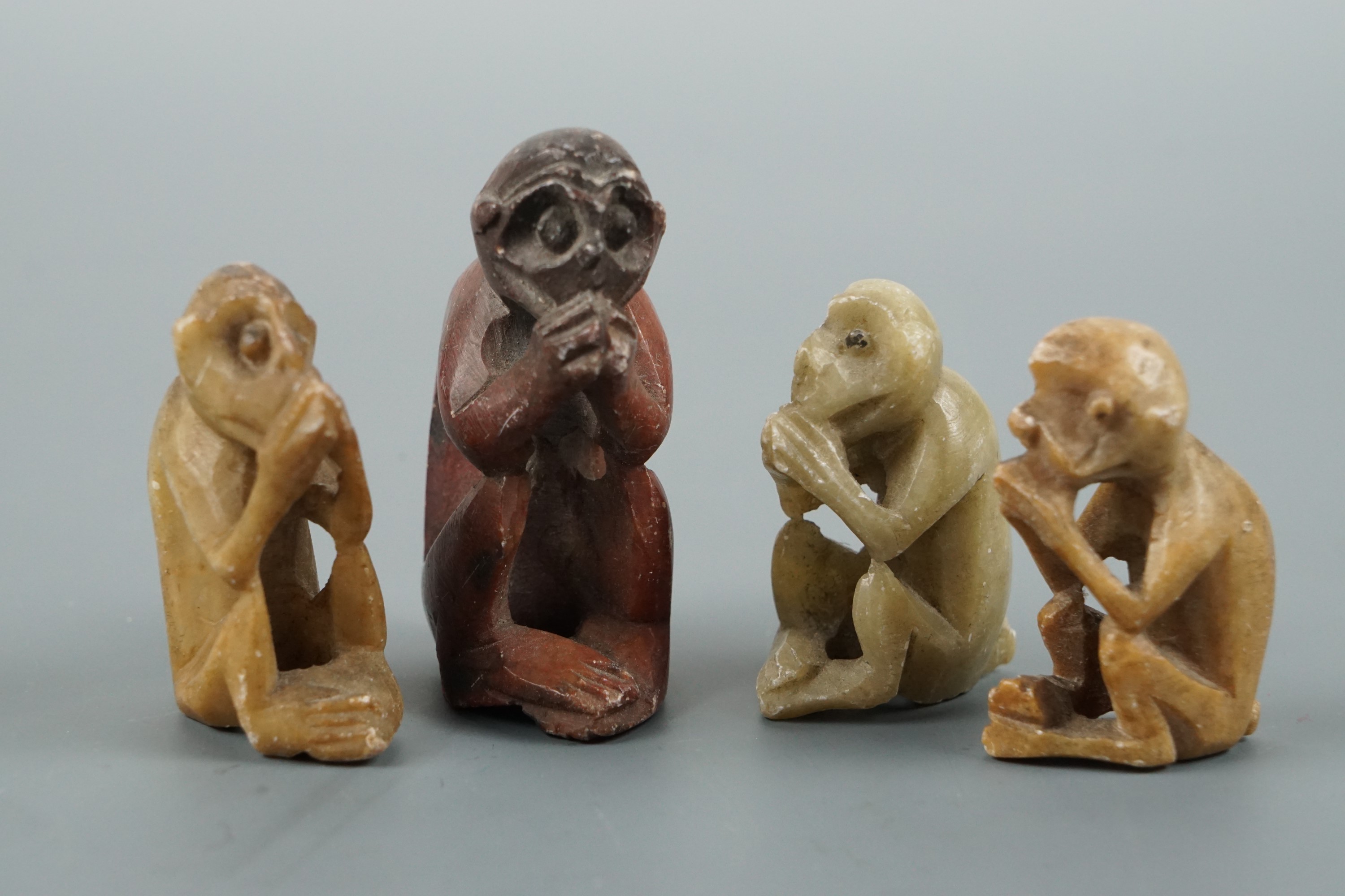 A graded group of four carved soapstone monkeys, tallest 4.5 cm