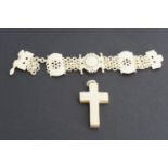 An early 20th Century carved ivory bracelet together with a pendant cross