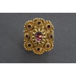 A 19th Century Anglo-Indian almandine garnet and yellow metal finger ring, its large cusped face set