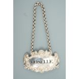 A Victorian Baroque silver bottle ticket for "Moselle", Charles Reily & George Storer, London, 1845,
