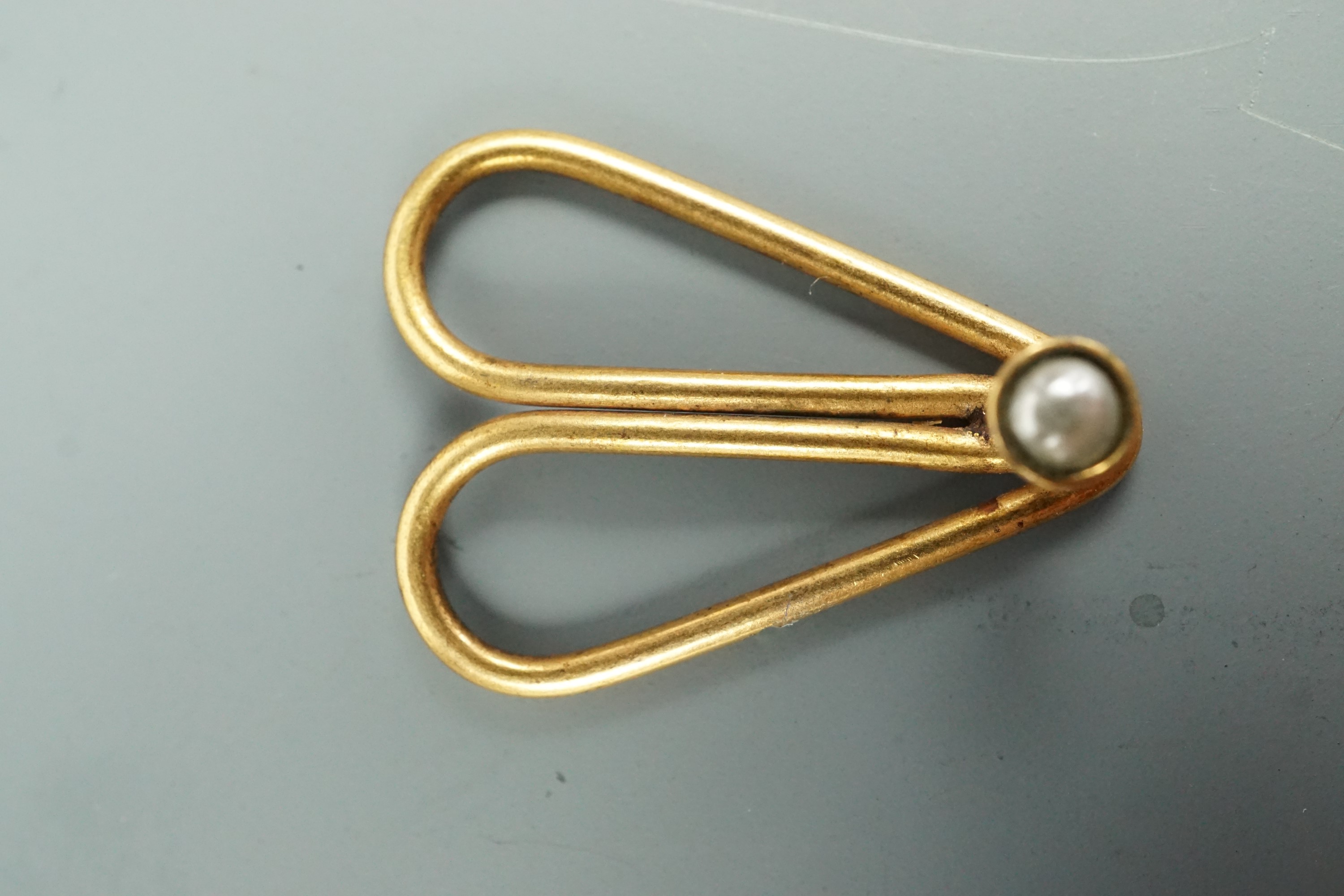 A Victorian patent tie clip set with a small pearl