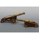 A turned and cast brass model canon on wooden truck / carriage, 34 cm, together with one other,