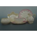 A group of Belleek porcelain including a shell pattern milk jug and sugar basin, a leaf dish and
