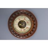 An oak carved barometer, 23 cm diameter