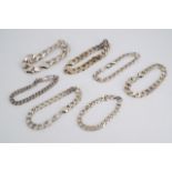 A quantity of silver / white metal heavy faceted curb link and marine link bracelets, 291 g