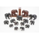 Carved wooden elephant bookends together with other elephant ornaments