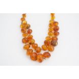A vintage Latvian amber necklace, with two strands of graded polished beads, on a base metal