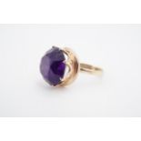 An amethyst dress ring, the 15 mm circular stone crown set on a 9 ct gold shank, O
