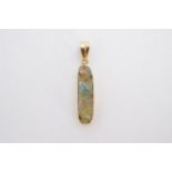 An opal pendant, the elongated oval stone set within a high carat yellow metal bezel, the