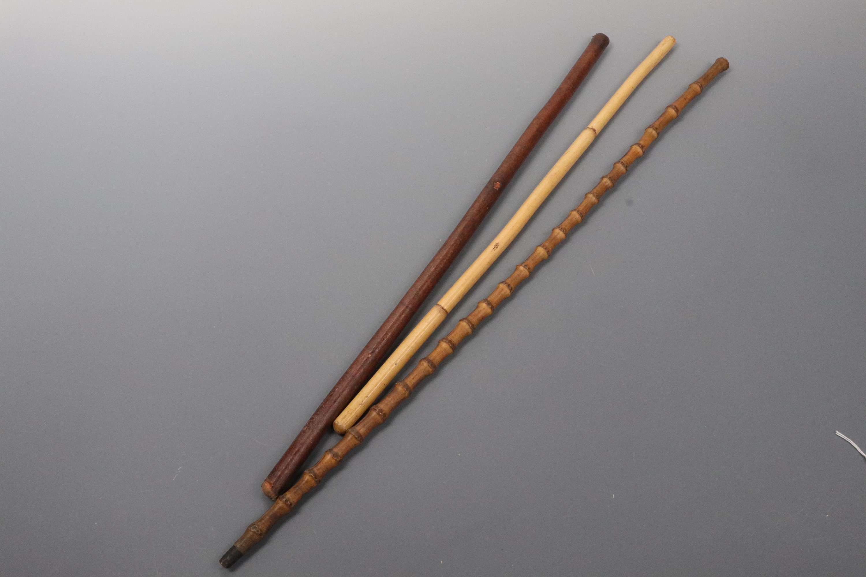 A hide-covered and two bamboo swagger sticks