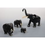Four carved wooden elephants