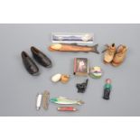 A miniature pair of clogs, miniature boots, penknives, matchbox cover etc.
