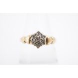 A diamond cluster ring, the small stones millegrain-set on a 9 ct gold shank, the shoulders faced