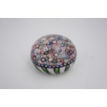 A mid 19th Century Clichy close-packed millefiori cane paperweight, the canes within a basket of