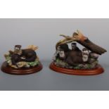 Two Border Fine Art otter figurines; River Hideaway A0401 and one other