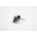 A vintage precious white metal, diamond and sapphire dress ring, comprising three oval-cut sapphires
