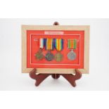 Framed 1914-15 Star, British War and Victory medals with Defence medal to 105844 Pte Hammond, MGC