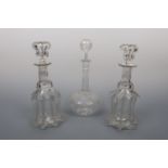 A pair of Victorian glass decanters of ribbed-bell form, together with a shaft and globe decanter