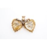 A Victorian yellow metal and citrine brooch in the form of two hearts and a thistle sprig, marked