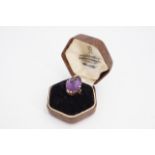 An amethyst cocktail ring, the navette shaped stone (21 x 13 mm) set on a yellow metal shank, O/P
