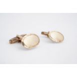 A pair of 1970s 9 ct gold cuff links, having oval faces and bullet backs, 7.4 g
