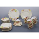A Roslyn China tea set for ten, in a Modernist influenced floral design, comprising tea cups, milk