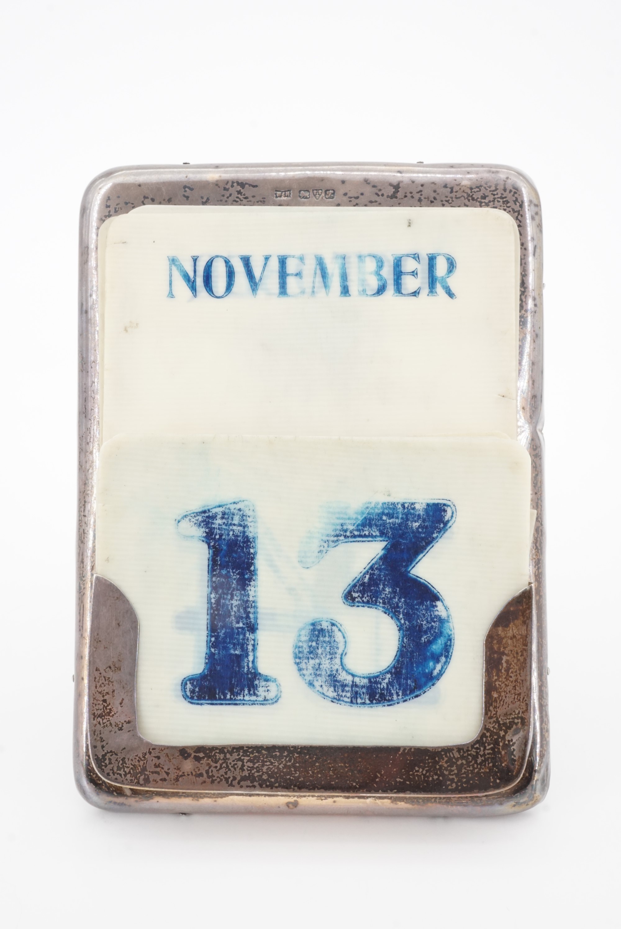 An Edwardian silver and Ivorine perpetual desk calendar, with oak easel back, Walker and Hall,