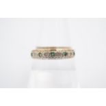 An emerald and diamond half hoop eternity ring, the small stones set on a 9 ct gold band, Q