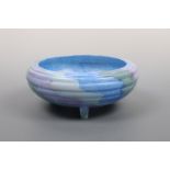 A Maling bowl / table centrepiece, of reeded oblate form on three feet, in a painterly blue pattern,
