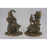 A pair of brass Punch and Judy door porters, 28 cm high
