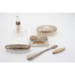 Two silver-lidded cut glass dressing table boxes, a silver-backed hair brush, silver-collared