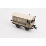 A Bing tinplate 0-gauge model railway guard's van in LMS livery, circa 1930s