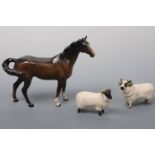 A Beswick horse and two Beswick black faced sheep