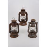 Three storm lanterns, 25 cm high