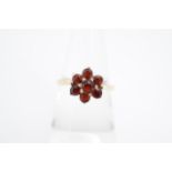 A garnet and 9 ct gold flowerhead cluster ring, K/L