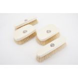 A set of Victorian ivory brushes, each bearing an engraved monogram