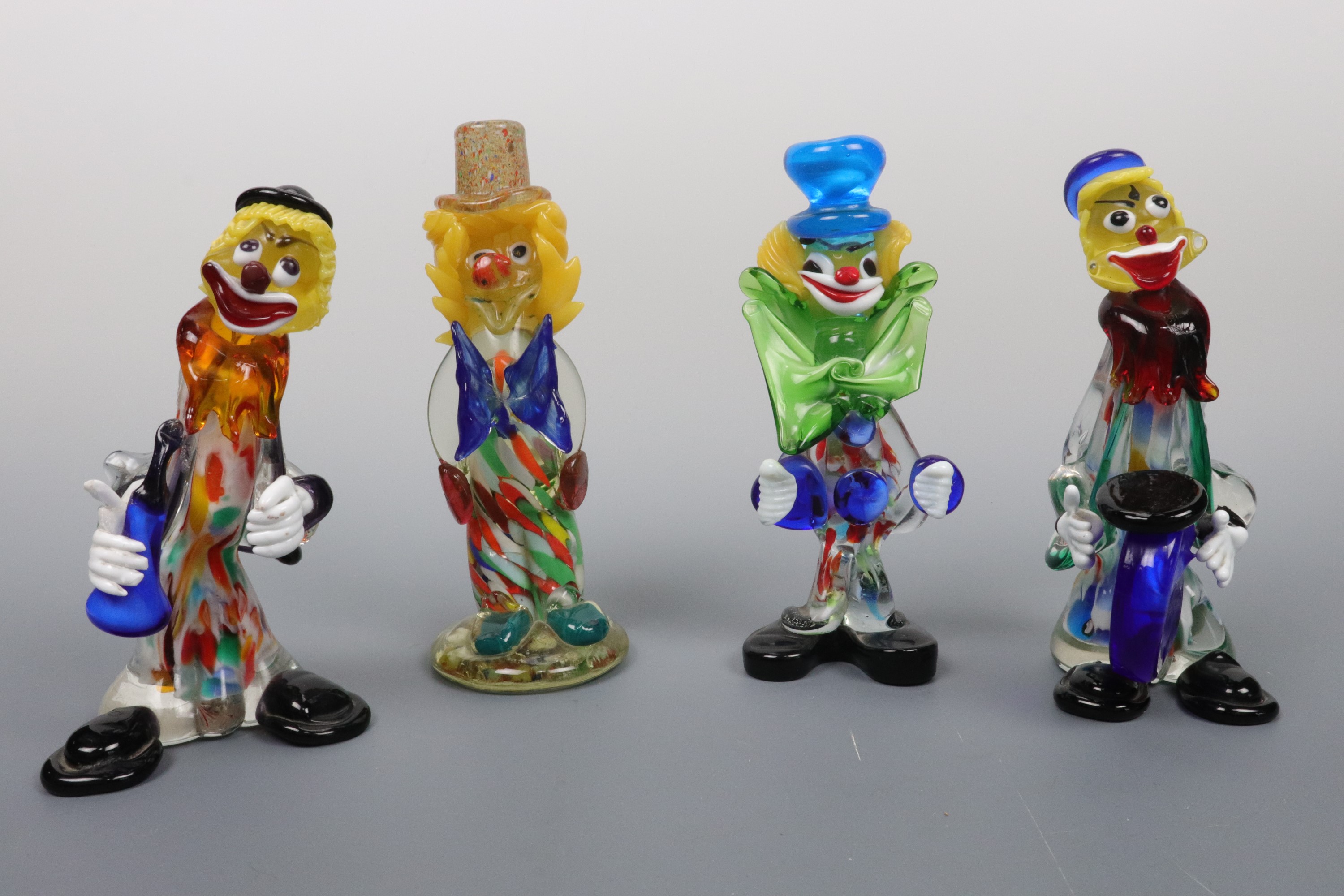 Four studio glass clowns, tallest 22 cm